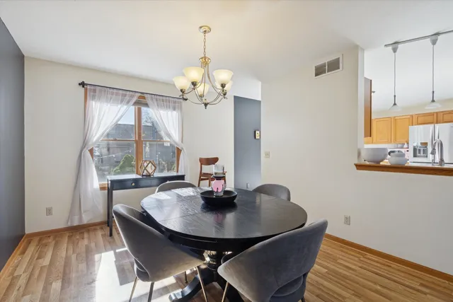 a view of a dining room with a table and chairs