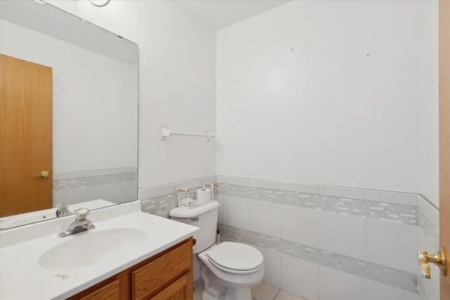 a bathroom with a sink a toilet and vanity