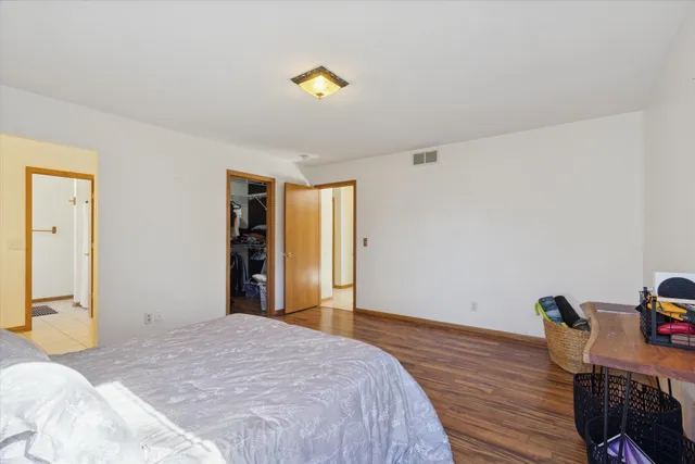 a bedroom with a bed and a dresser