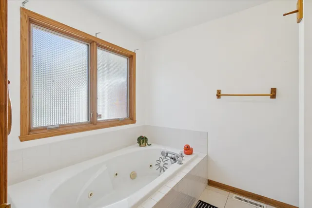 a bathroom with a bathtub and a window