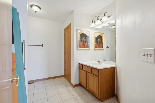 a bathroom with a sink vanity and a mirror