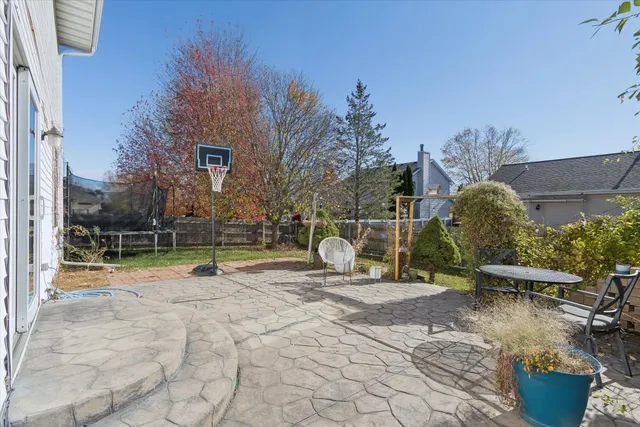 a view of a backyard with sitting area and slide