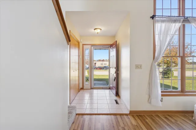 a view of a hallway with wooden floor and staircase