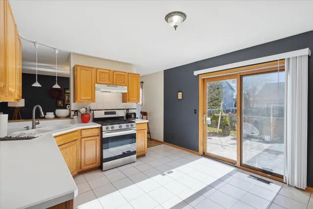 a kitchen with stainless steel appliances granite countertop a stove and a sink