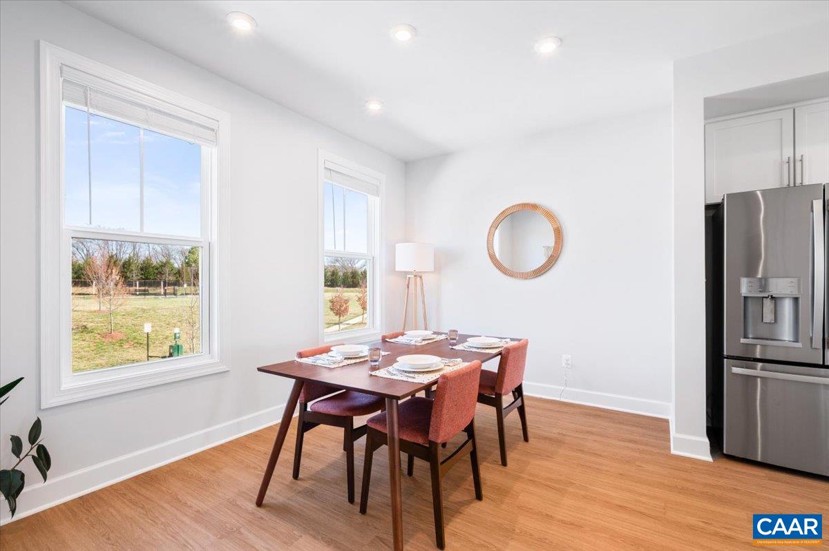 5963 McComb Street Crozet, VA 22932 - Photo 26 of 65 a view of a dining room with furniture window and wooden floor