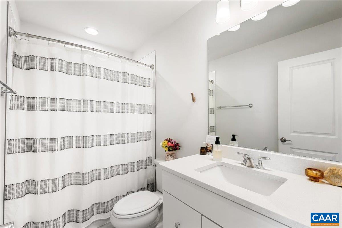 5963 McComb Street Crozet, VA 22932 - Photo 34 of 65 a bathroom with a sink and a mirror
