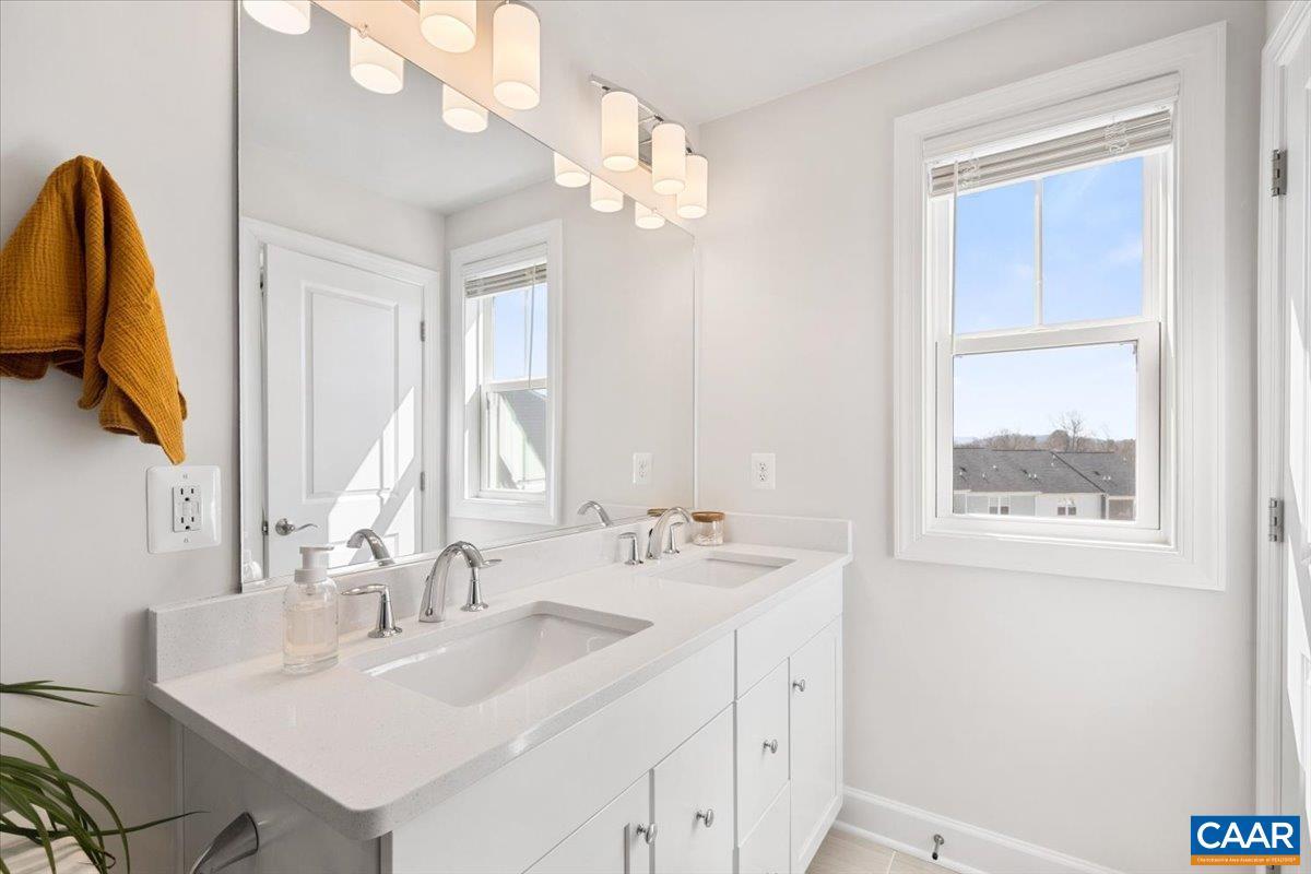 5963 McComb Street Crozet, VA 22932 - Photo 40 of 65 a bathroom with a sink vanity and a mirror