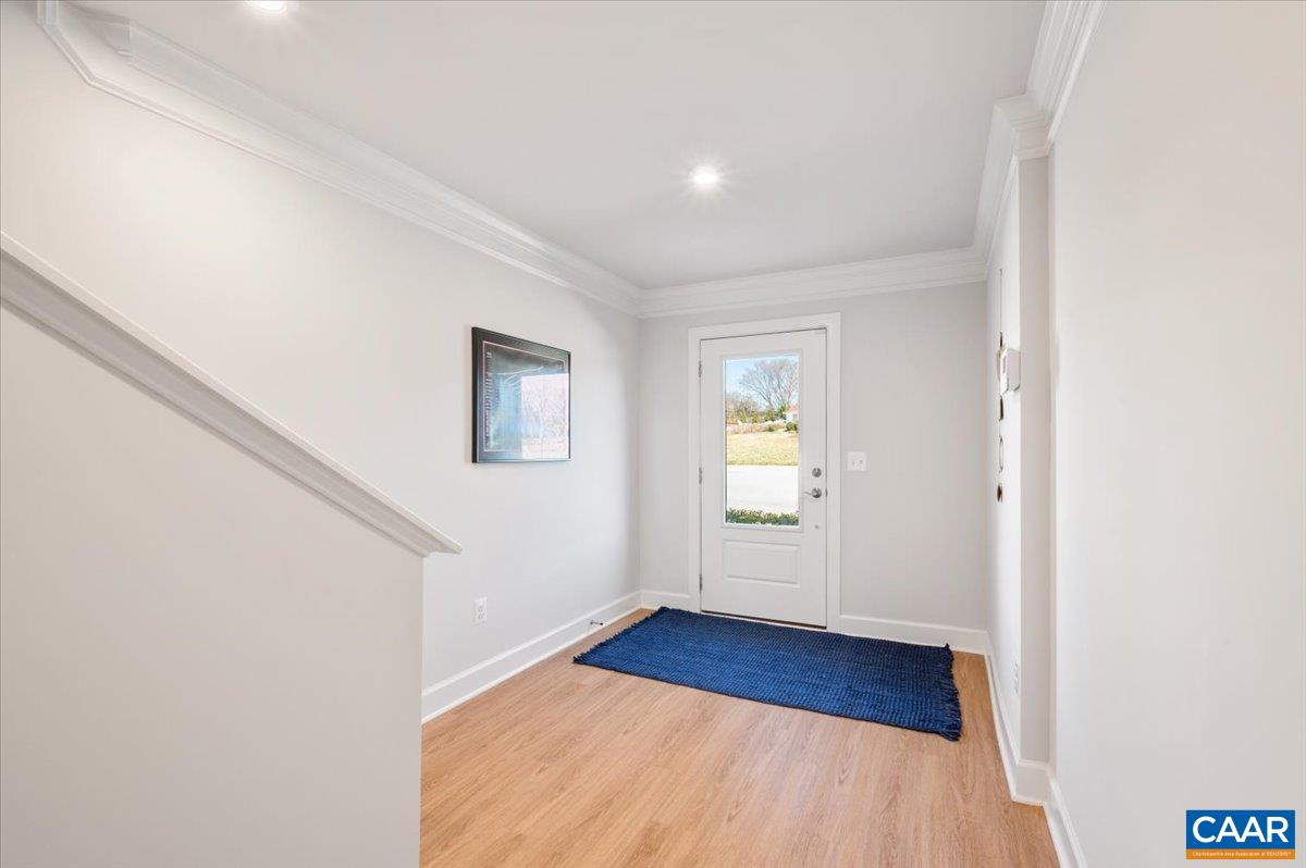 5963 McComb Street Crozet, VA 22932 - Photo 5 of 65 a view of an empty room with wooden floor and a window