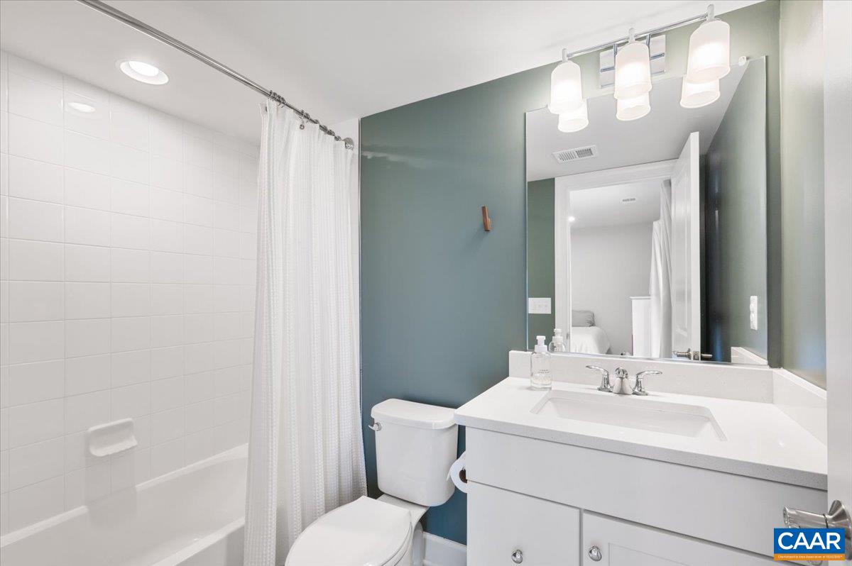 5963 McComb Street Crozet, VA 22932 - Photo 9 of 65 a bathroom with a sink toilet and shower