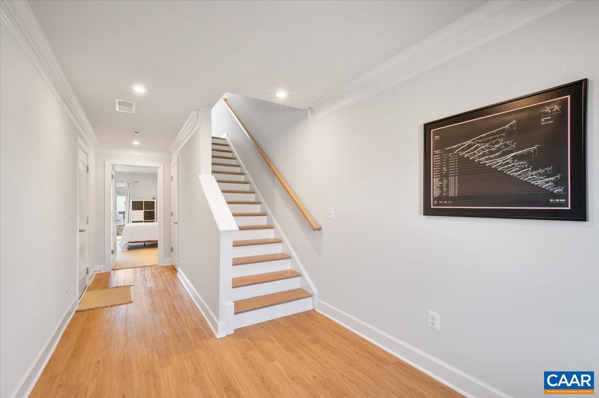 5963 McComb Street Crozet, VA 22932 - Photo 10 of 65 a view of a hallway with wooden floor and staircase
