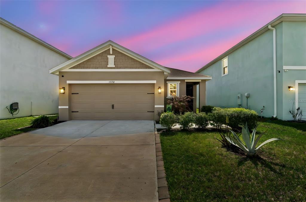 a front view of a house with a yard