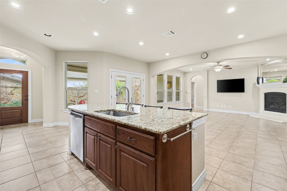 116 Trailing Lantana Drive, Unit G Georgetown, TX 78628 - Photo 13 of 38 a kitchen with stainless steel appliances granite countertop a sink and a refrigerator