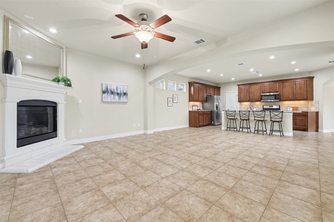 116 Trailing Lantana Drive, Unit G Georgetown, TX 78628 - Photo 17 of 38 a view of a kitchen with furniture and a fireplace