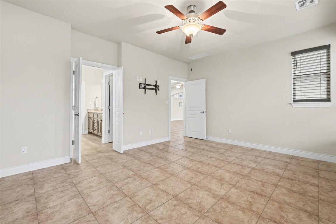 116 Trailing Lantana Drive, Unit G Georgetown, TX 78628 - Photo 22 of 38 an empty room with closet and a chandelier fan
