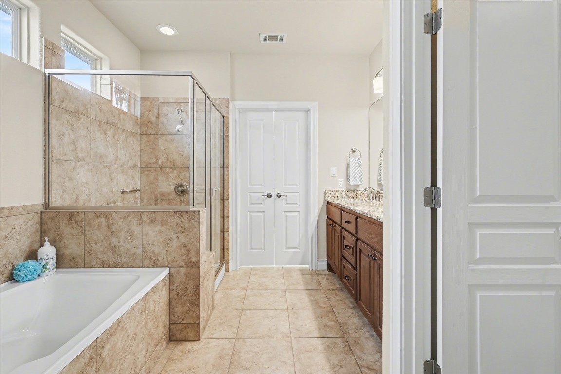 116 Trailing Lantana Drive, Unit G Georgetown, TX 78628 - Photo 25 of 38 a bathroom with a tub sink and shower