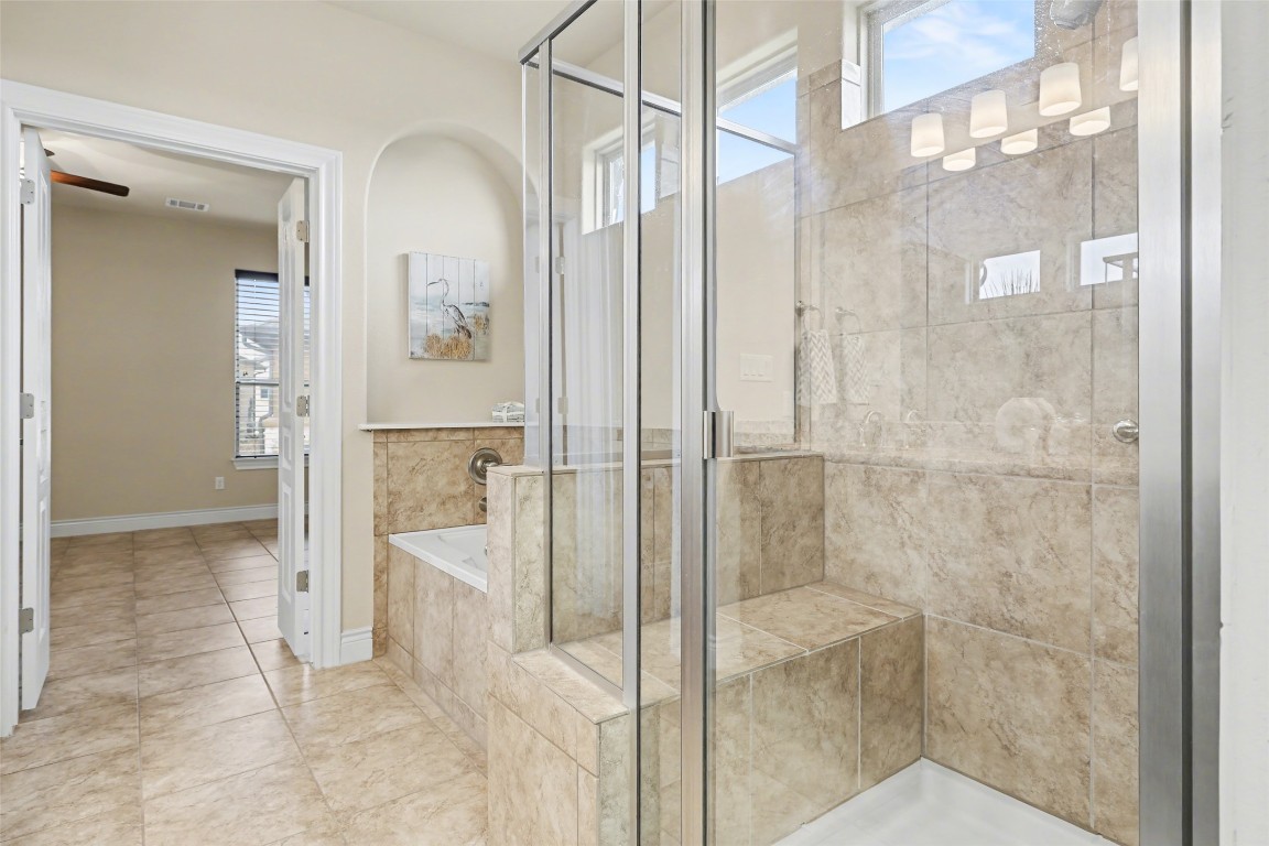 116 Trailing Lantana Drive, Unit G Georgetown, TX 78628 - Photo 27 of 38 a bathroom with a glass shower door and a mirror