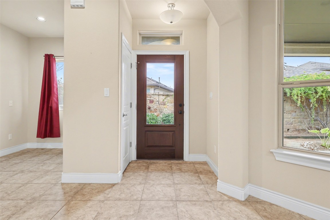116 Trailing Lantana Drive, Unit G Georgetown, TX 78628 - Photo 5 of 38 a view of a hallway with wooden floor and windows