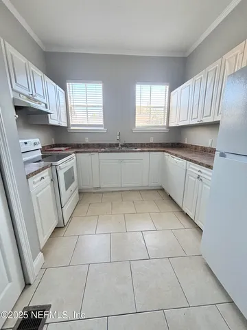 a kitchen with stainless steel appliances granite countertop a stove a sink and a granite counter tops
