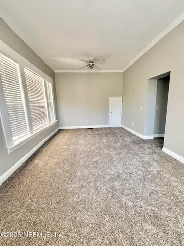 an empty room with windows and closet
