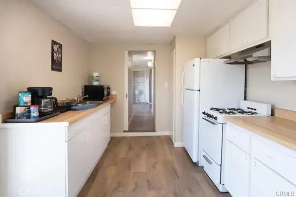 a kitchen with a refrigerator and a stove top oven