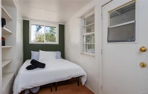 a bedroom with a bed and a window