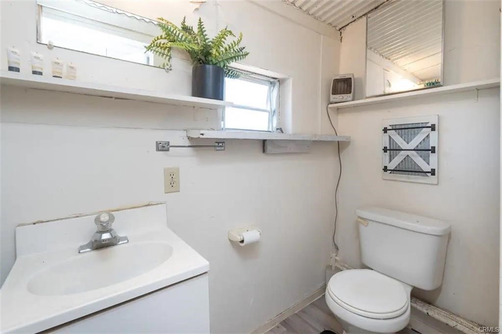 38797 Highway 41 Oakhurst, CA 93644 - Photo 19 of 27 a bathroom with a sink a mirror and a toilet