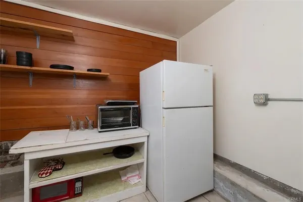 a kitchen with a refrigerator and a stove