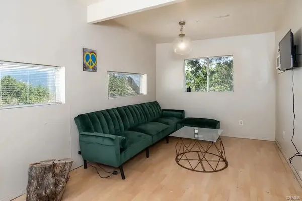a living room with furniture and a wall painting
