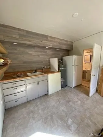 a view of a kitchen with refrigerator and microwave