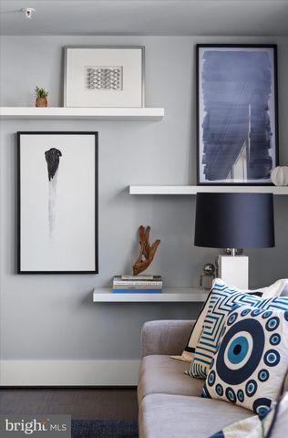 a living room with furniture flat screen tv and potted plant