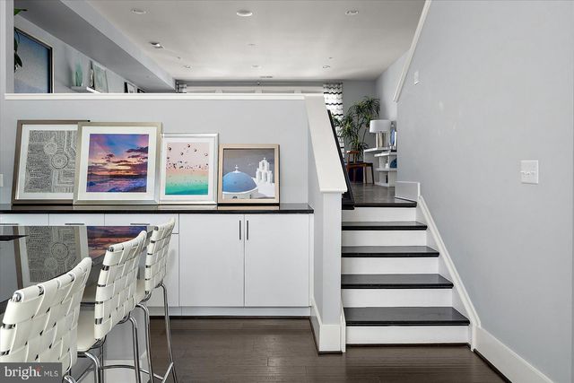 a kitchen with a refrigerator and a table