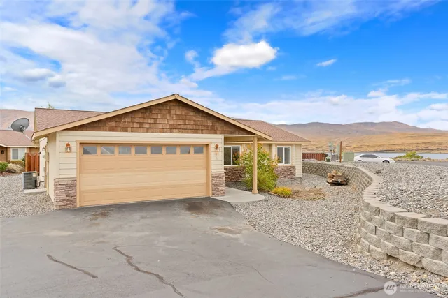 a view of a house with backyard and wooden fence