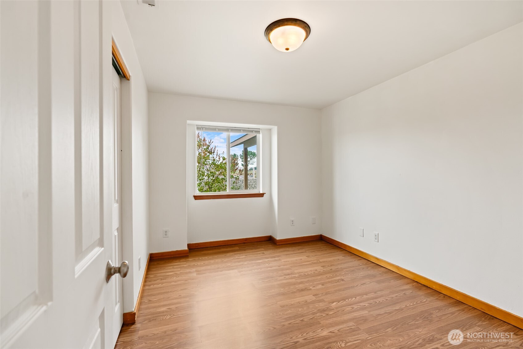 509B Clubhouse Way, Unit A Mattawa, WA 99349 - Photo 16 of 29 an empty room with wooden floor and windows