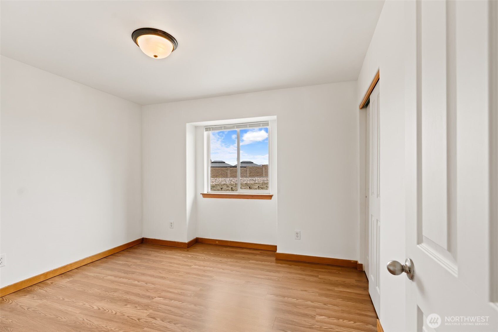 509B Clubhouse Way, Unit A Mattawa, WA 99349 - Photo 22 of 29 a view of an empty room with wooden floor and a window