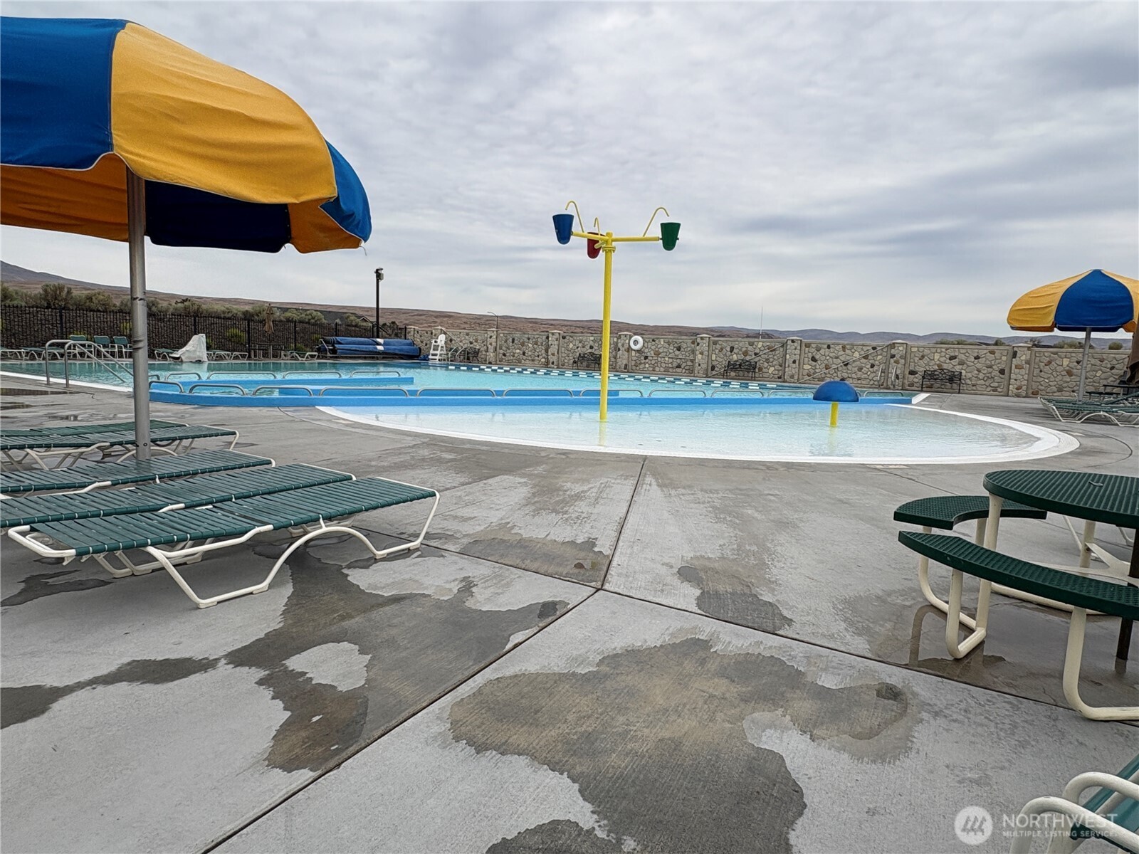 509B Clubhouse Way, Unit A Mattawa, WA 99349 - Photo 6 of 29 a view of a swimming pool with a chair and tables