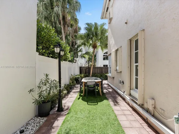 a view of a patio with table and chairs and potted plants