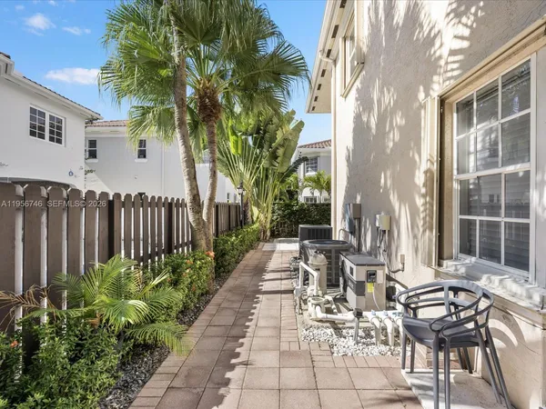 a living room with lots of furniture and kitchen view