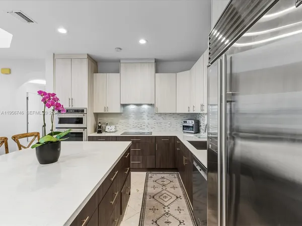 a living room with furniture a wooden floor and a large window