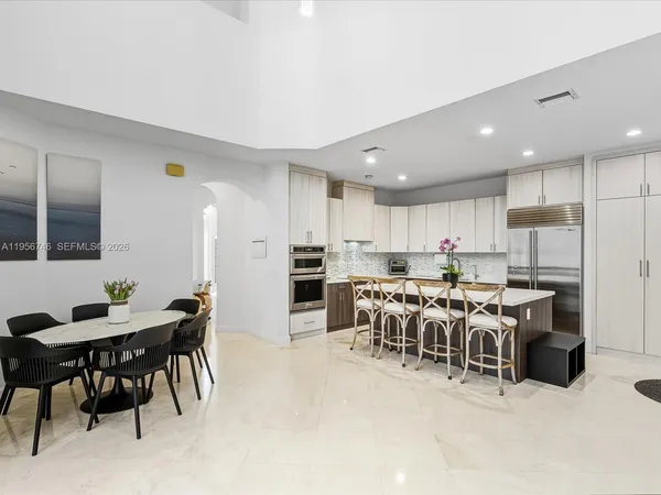 a living room with furniture a rug and a large window