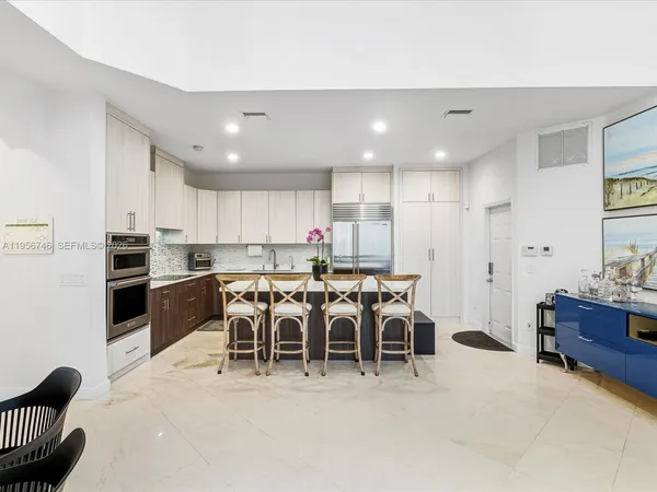 a living room with furniture and a dining table
