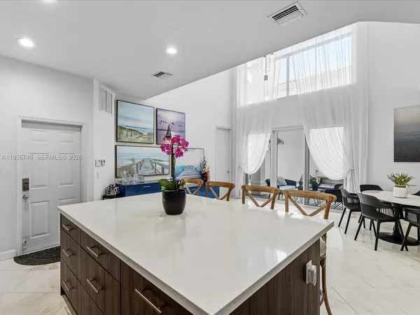 a view of a dining room with furniture and chandelier