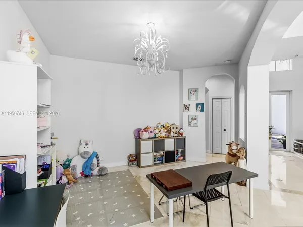 a view of a hallway with dining room and wooden floor