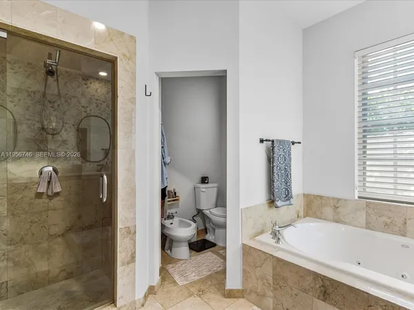 a en suite bathroom with a granite countertop sink and a mirror