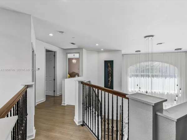 an aerial view of residential houses with outdoor space and swimming pool