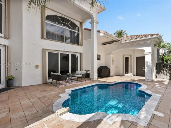 a swimming pool with outdoor seating