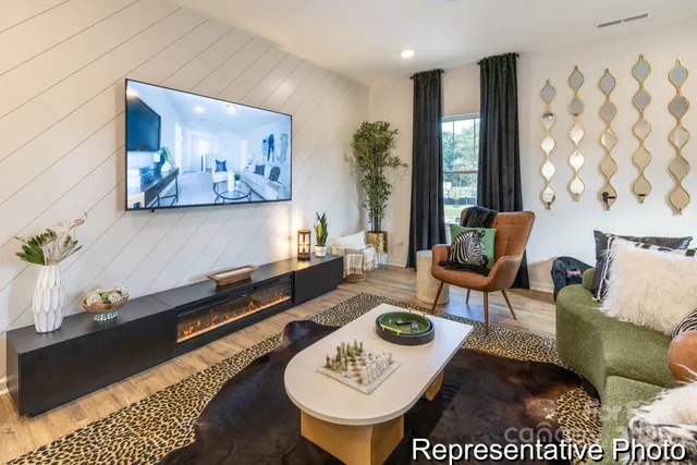 a living room with furniture and wooden floor