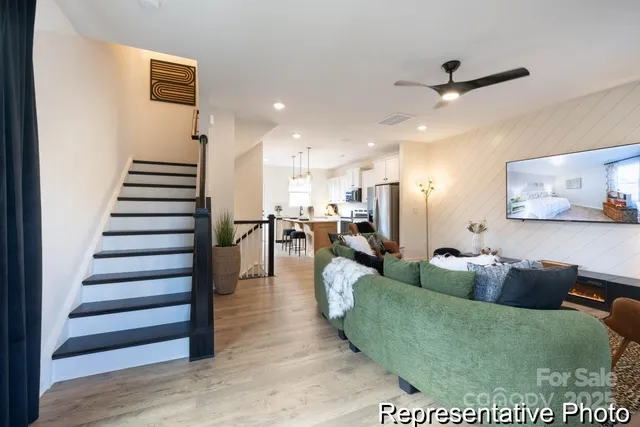 a living room with furniture and wooden floor