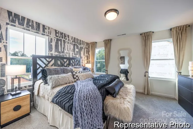 a bedroom with a bed and a large window