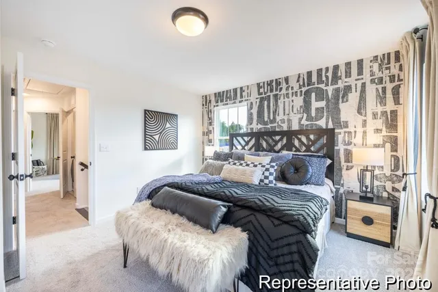 a bedroom with a bed and a night stand