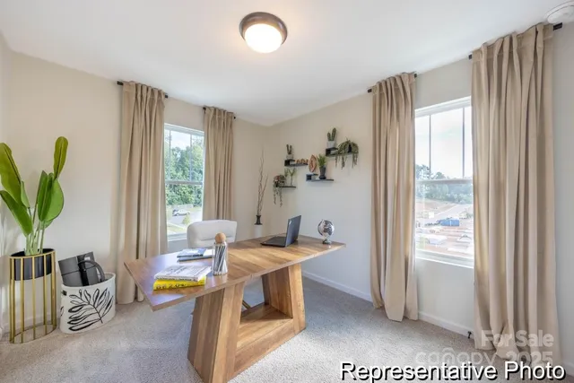 a dining room with furniture and a potted plant